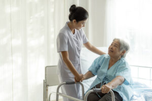 Elderly woman with nurse in aged care.